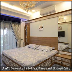 Geometric Jaalis made from laminate surround the bed face drawers wall skirting & ceiling